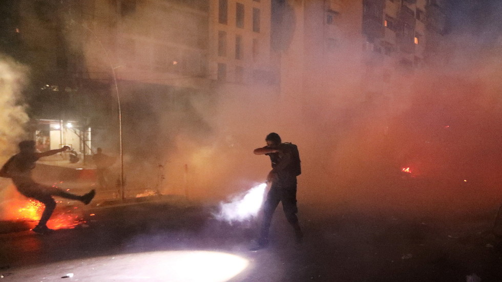 Beirut blast demonstrators get past riot police and tear gas, smash front of minister’s home