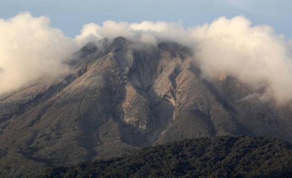 Philippines raises alert level at restive volcano after spewing cloud of ash